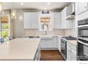 Bright kitchen featuring white cabinets, stainless steel appliances, a butcher block island, and wood floors at 803 Old Wagon Trail Cir, Lafayette, CO 80026