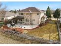 Aerial view showcases a large backyard, covered patio, and wooden fence at 1145 Wyndemere Cir, Longmont, CO 80504