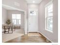 Inviting entryway with hardwood floors, white front door, and view to a study room at 1160 Summit View Dr, Louisville, CO 80027