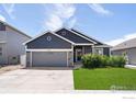 Beautifully landscaped single Gathering home with a manicured lawn, 2-car garage and a welcoming entrance at 1525 Waterman St, Berthoud, CO 80513
