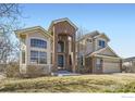 Attractive two-story home with brick accents, large windows, and a well-manicured front lawn at 16021 Verbena St, Brighton, CO 80602