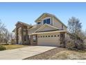 Spacious two-story home with a two-car garage and a brick and siding exterior at 16021 Verbena St, Brighton, CO 80602