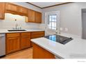 Kitchen features stainless steel appliances, white countertops, and hardwood floors at 1735 S Kline Way, Lakewood, CO 80232