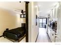 Cozy bedroom featuring a dark-colored bed and contemporary design, adjoining a view of the kitchen and balcony at 1800 Pearl St # 15, Boulder, CO 80302