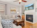 Inviting living room with a cozy fireplace, hardwood floors, and stylish decor at 2014 Pintail Dr, Longmont, CO 80504