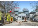 View of the exterior of the building with a center courtyard featuring concrete benches and a small tree at 2018 Ionosphere St # 3, Longmont, CO 80504