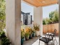 Charming covered patio with views of the neighborhood and attractive potted plants and comfortable seating at 2125 Eliot St, Denver, CO 80211