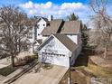 Aerial view of a two-story home with a two-car garage, showcasing its location in a residential area at 2201 Watersong Cir, Longmont, CO 80504