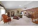 Spacious living room with vaulted ceiling, large windows, and elegant decor at 2418 Maplewood E Cir, Longmont, CO 80503