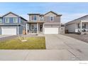 Charming two-story home with a two-car garage, covered porch and landscaped front yard at 2425 Mountain Sky Dr, Fort Lupton, CO 80621