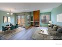 Bright living room with a fireplace and access to an outdoor patio at 3076 Fulton Cir, Boulder, CO 80301