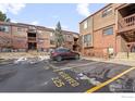 Exterior view of a multi-Gathering complex with brick and wood facade, balconies, and reserved parking spots at 316 Wright St # 203, Lakewood, CO 80228