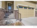 Close-up of the two-car garage and front door showcasing the stone facade and entry steps at 3325 Yale Dr, Broomfield, CO 80023