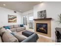 Cozy living room with a modern fireplace, balcony access, and stylish decor at 3401 Arapahoe Ave # 406, Boulder, CO 80303