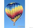 Vibrant hot air balloon against a clear blue sky, suggesting an adventurous and scenic location at 355 8Th St, Frederick, CO 80530