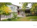 Inviting front yard of a gray home with mature trees at 4705 Chatham St, Boulder, CO 80301