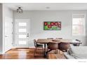 Bright dining room features a wood table, seating for six and hardwood floors at 784 Stonebridge Dr, Longmont, CO 80503