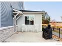 Outdoor patio area with two rocking chairs and a grill, perfect for entertaining at 784 Stonebridge Dr, Longmont, CO 80503