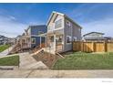 Attractive modern home with a covered porch and a well-maintained lawn at 10291 E 62Nd Pl, Denver, CO 80238
