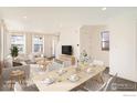 Bright and airy living room and dining room with modern furnishings and ample natural light at 10331 E 62Nd Pl, Denver, CO 80238