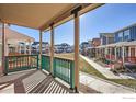 Inviting front porch with decorative railing and a view of the colorful neighborhood at 10331 E 62Nd Pl, Denver, CO 80238