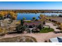 Waterfront property featuring lush trees, home, and waterfront access at 10752 County Road 7, Longmont, CO 80504