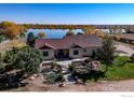 Charming home with beautiful landscaping, mature trees, and waterfront views at 10752 County Road 7, Longmont, CO 80504