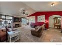 Inviting living room with plush carpet, fireplace, adjacent dining room and large picture window at 10752 County Road 7, Longmont, CO 80504