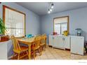 Cozy dining room with classic table set and natural light from two windows at 1256 Ulster St, Denver, CO 80220