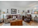 Warm and inviting living room featuring plush seating, lamps, and stylish accents at 1420 Hover St # 2, Longmont, CO 80501