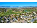 A neighborhood with a golf course and mountain views in the background at 1853 Rannoch Dr, Longmont, CO 80504