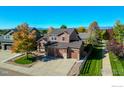 A beautiful aerial view of a two-story home showcasing a well-manicured lawn and a welcoming three car driveway at 1853 Rannoch Dr, Longmont, CO 80504