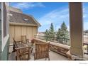 Outdoor patio with wood furniture, stone accents, and a serene view of the surrounding neighborhood at 1856 Kalel Ln, Louisville, CO 80027