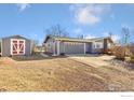 Home exterior featuring an attached garage, shed, and well-maintained gravel driveway at 200 Bothun Rd, Berthoud, CO 80513
