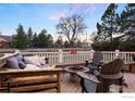 Cozy outdoor deck with comfortable seating around a fire pit, ideal for enjoying cool evenings at 2527 Columbine Cir, Lafayette, CO 80026