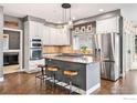 Modern kitchen featuring a spacious island, stainless steel appliances, and ample cabinet space at 2527 Columbine Cir, Lafayette, CO 80026