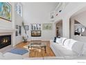 Inviting living room features fireplace, hardwood floors, lots of natural light, and stylish decor at 5338 Pine Valley Ct, Boulder, CO 80301