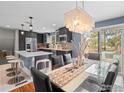 Stylish kitchen with modern appliances, sleek cabinetry, a large island, and an adjacent dining area at 5355 Kewanee Dr, Boulder, CO 80303