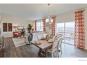 Inviting dining area with stylish table setting, opening to living space and balcony with scenic views at 6513 14Th St, Frederick, CO 80530