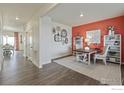 Bright home office area with modern desk, stylish decor, and seamless flow into the dining and living spaces at 6513 14Th St, Frederick, CO 80530