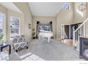 Elegant living room featuring soaring ceilings, a grand piano, and lots of natural light at 730 Pope Dr, Erie, CO 80516