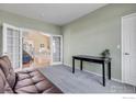 Bright home office showcasing French doors, a dark desk, and a comfortable seating area at 730 Pope Dr, Erie, CO 80516
