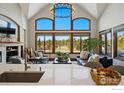 Open-concept space flows between the kitchen and living room with fireplace and windows at 8733 Portico Ln, Longmont, CO 80503