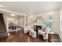 Bright living room with hardwood floors, a cozy fireplace, and elegant decor creating a warm ambiance at 1013 Mapleton Ave, Boulder, CO 80304