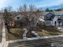 An aerial view of a neighborhood street showing the manicured lawns and modern home designs at 1028 Rex St # B102, Louisville, CO 80027