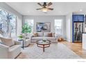 Bright living room with modern furnishings, large windows, and open floor plan at 1028 Rex St # B102, Louisville, CO 80027