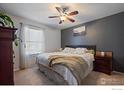 Comfortable bedroom featuring a ceiling fan, large window, and soothing neutral tones at 10781 Moore St, Westminster, CO 80021