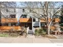 Townhome exterior showing brick facade, light-blue siding, private wood balcony, and bridge entrance at 1111 Maxwell Ave # 231, Boulder, CO 80304