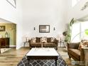 Spacious living room with high ceilings, hardwood floors, and a decorative rug at 12023 Coal Creek Heights Dr, Golden, CO 80403