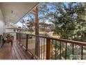 Outdoor wooden deck with patio furniture overlooking the community at 1402 Athene Dr, Lafayette, CO 80026